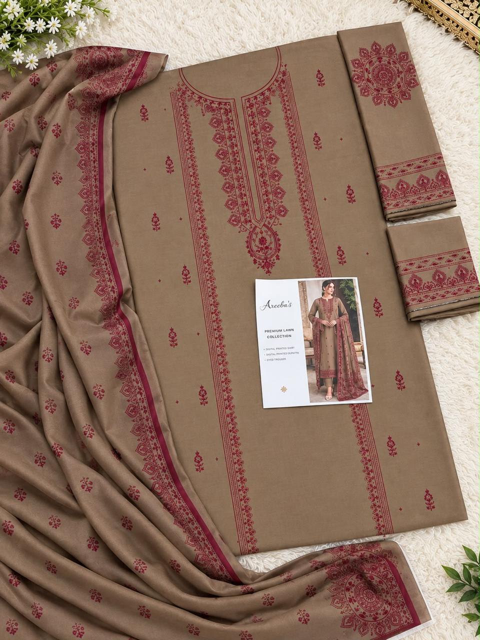 A flat-lay presentation of a women's Pakistani ethnic shalwar suit set, featuring a brown kurta with red embroidery, matching trousers, and a dupatta, displayed on a white textured background with a brand card.